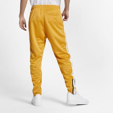 nike track pants yellow
