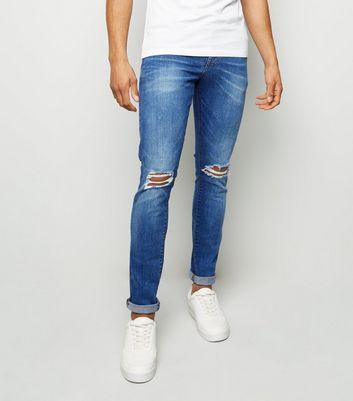 Hellblaue Skinny-jeans Mit Rissen Am Knie