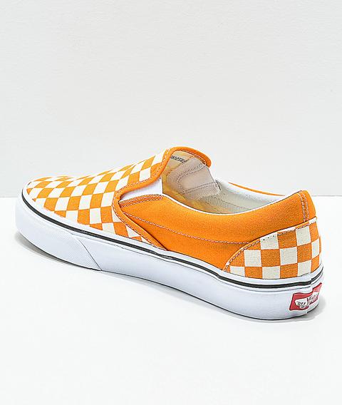 orange and white slip on vans